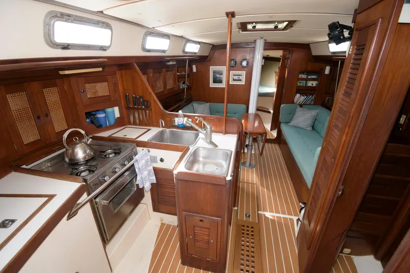 Slide: The Image of 1985 Tartan 40 yacht interior with kitchen, sink, and seating area. - 14