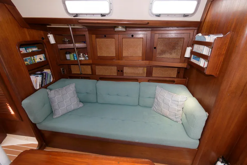 Slide: The Image of Interior of 1985 Tartan 40 sailboat with green sofa and wooden cabinetry. - 18