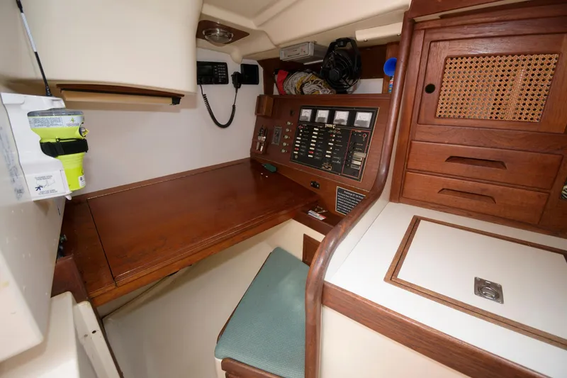 Slide: The Image of 1985 Tartan 40 sailboat navigation station with wooden desk and control panel. - 20