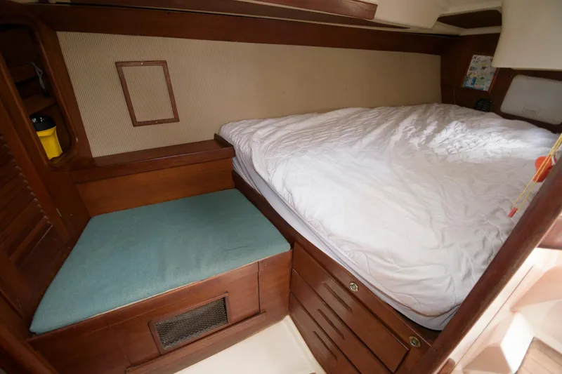 Slide: The Image of Cozy cabin interior of 1985 Tartan 40 sailboat with bed and seating area. - 21