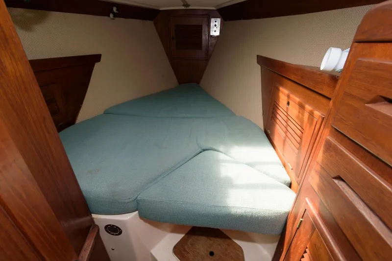 Slide: The Image of 1985 Tartan 40 sailboat interior cabin with V-berth and wooden cabinetry - 22