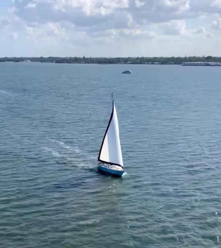 Slide: The Image of 1985 Tartan 40 sailboat cruising on a calm sea under a partly cloudy sky. - 4