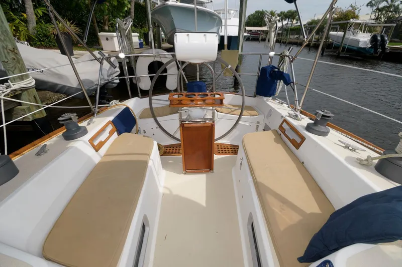 Slide: The Image of Cockpit of a 1985 Tartan 40 sailboat with beige cushions and wooden accents. - 7