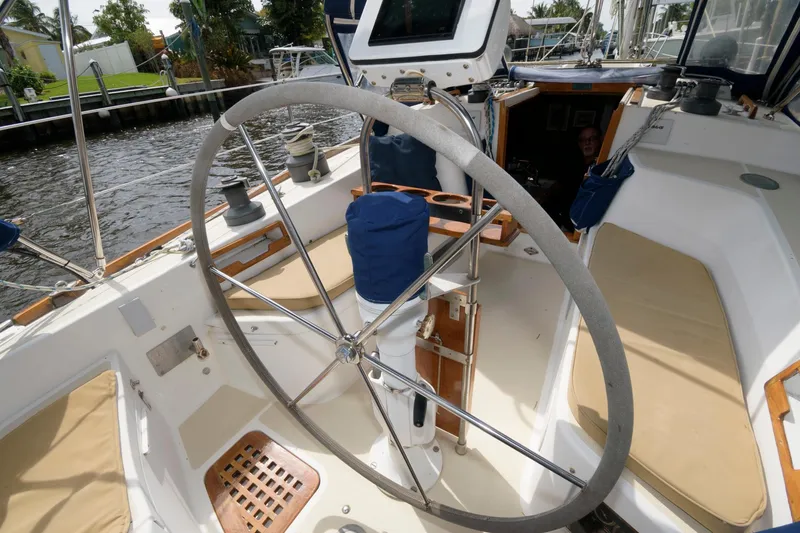 Slide: The Image of Cockpit of 1985 Tartan 40 sailboat with large steering wheel and seating area. - 9