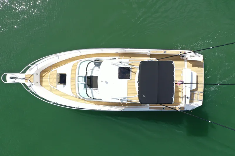 The Image of Overhead view of 1992 Luhrs 300 Tournament boat on green water. - 0