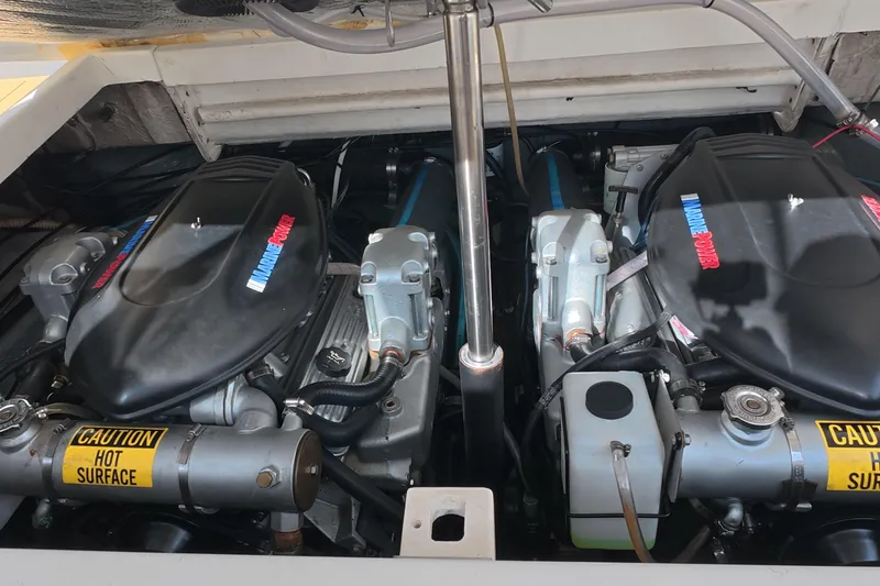Slide: The Image of Engine compartment of a 1992 Luhrs 300 Tournament boat, featuring twin marine engines. - 17