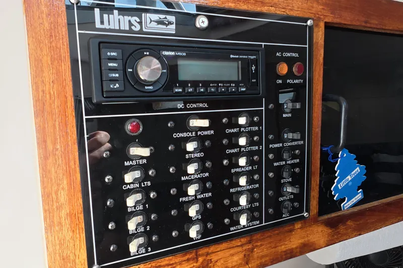 Slide: The Image of Control panel of a 1992 Luhrs 300 Tournament boat with various switches and a stereo system. - 20