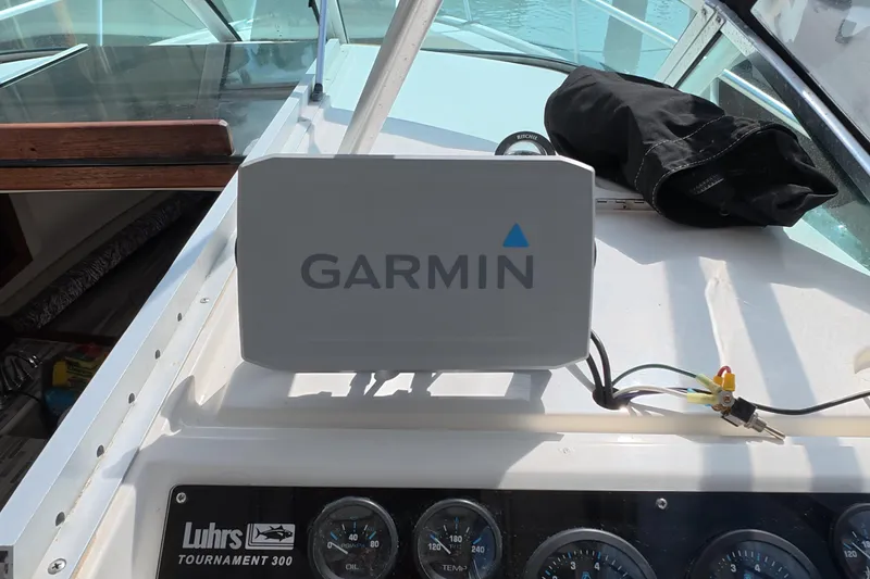 Slide: The Image of Garmin device on 1992 Luhrs 300 Tournament boat dashboard with gauges. - 21