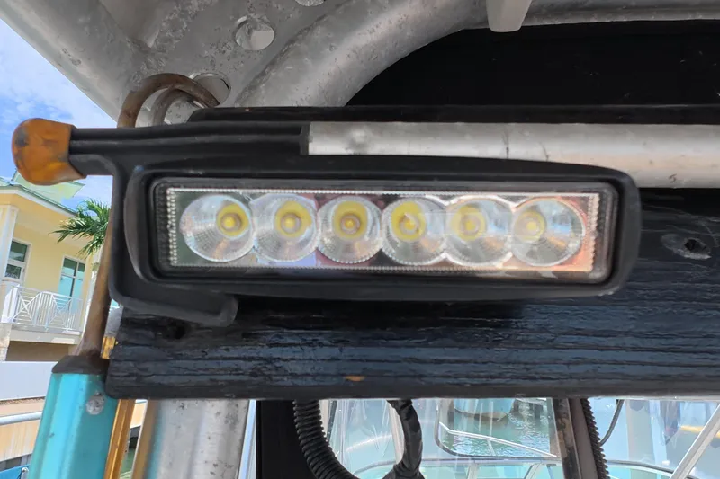 Slide: The Image of Close-up of LED light on 1992 Luhrs 300 Tournament boat, docked near a building. - 25