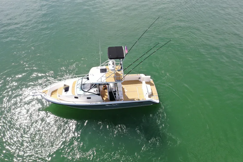 Slide: The Image of 1992 Luhrs 300 Tournament boat on calm green water, aerial view. - 3