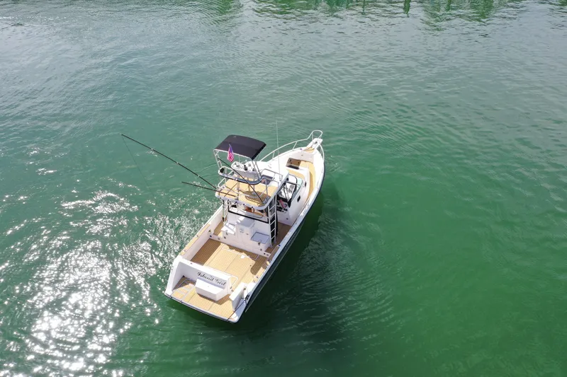 Slide: The Image of 1992 Luhrs 300 Tournament boat on calm green water, aerial view. - 4