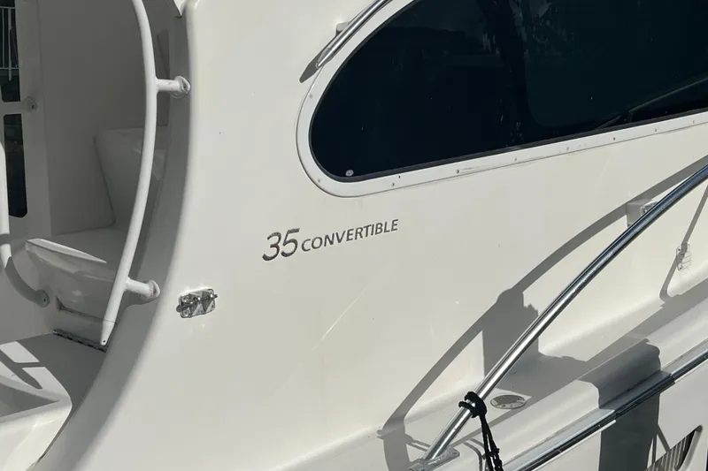 Slide: The Image of 2008 Luhrs 35 Convertible boat exterior with sleek design and window detail. - 13