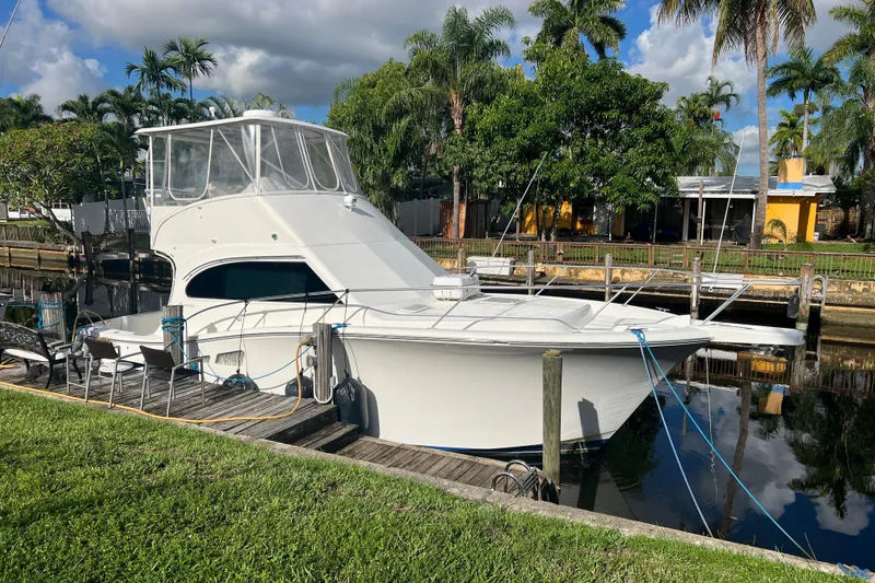 Slide: The Image of 2008 Luhrs 35 Convertible yacht docked by lush tropical scenery. - 14