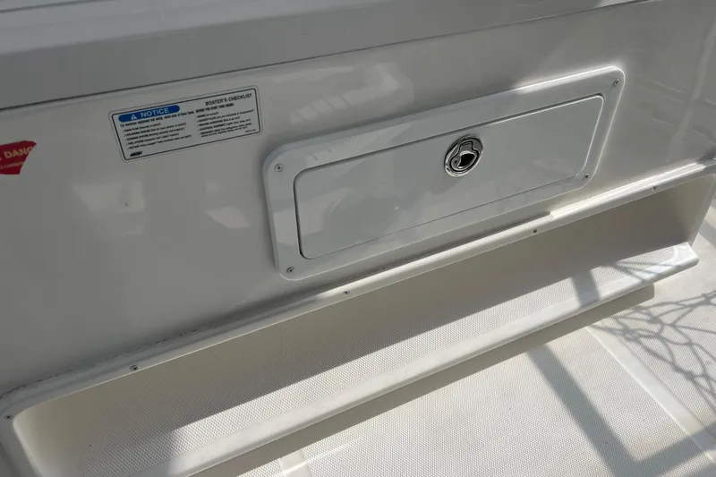 Slide: The Image of 2008 Luhrs 35 Convertible boat storage compartment with safety notice and lock. - 20