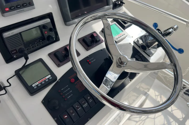 Slide: The Image of Steering console of 2008 Luhrs 35 Convertible boat with navigation instruments. - 23
