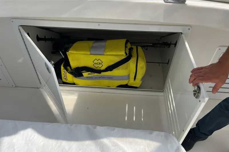 Slide: The Image of Storage compartment on 2008 Luhrs 35 Convertible with yellow ACR emergency bag. - 26