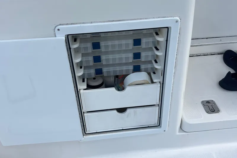 Slide: The Image of Storage compartment on 2008 Luhrs 35 Convertible boat with organized drawers and containers. - 29