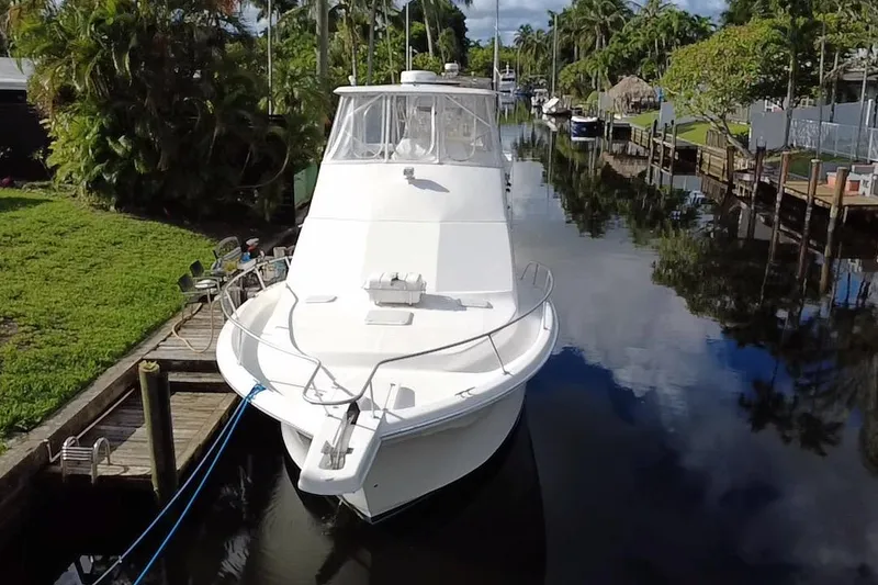 Slide: The Image of 2008 Luhrs 35 Convertible boat docked in a scenic canal setting. - 3