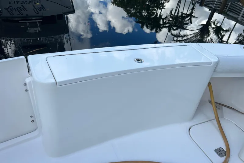 Slide: The Image of 2008 Luhrs 35 Convertible boat deck with storage compartment and water reflections. - 32