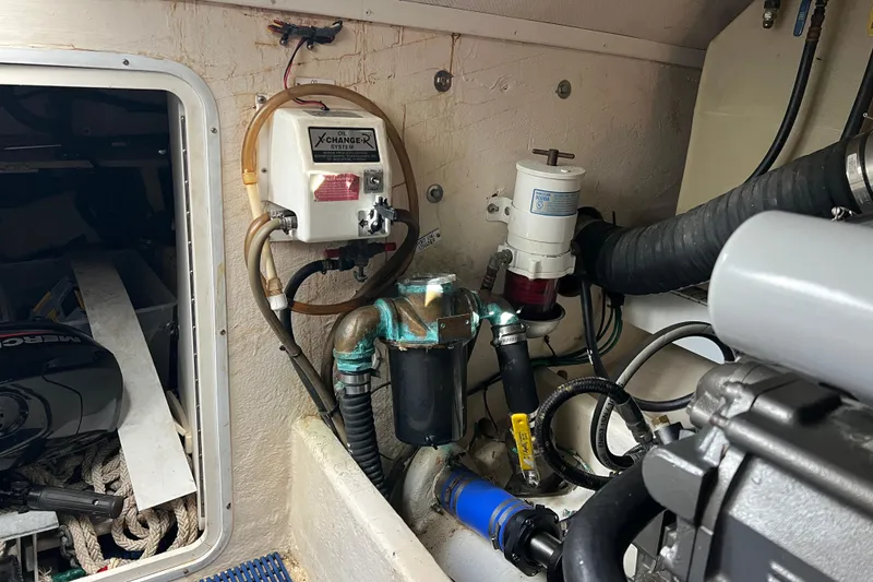 Slide: The Image of Engine room of 2008 Luhrs 35 Convertible boat with oil changer system and hoses. - 36