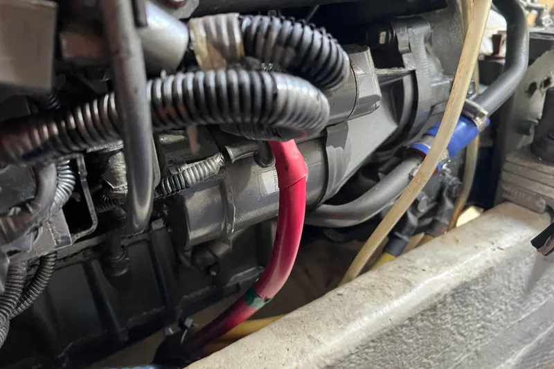 Slide: The Image of Engine components of a 2008 Luhrs 35 Convertible boat, featuring wiring and hoses. - 37