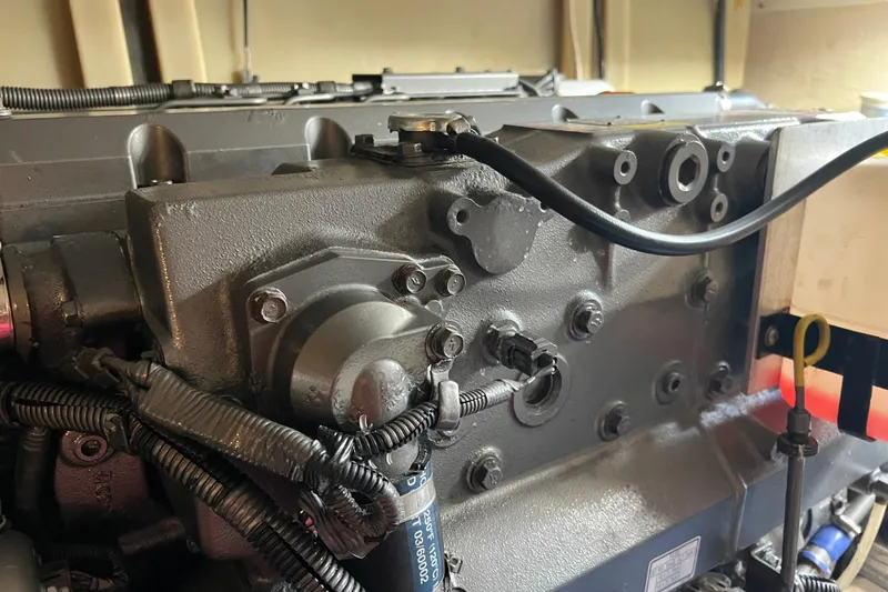 Slide: The Image of Engine compartment of a 2008 Luhrs 35 Convertible boat, showcasing mechanical components and wiring. - 38