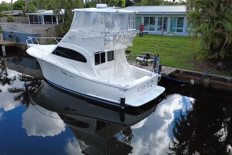 Slide: The Image of 2008 Luhrs 35 Convertible yacht docked by a waterfront home. - 4