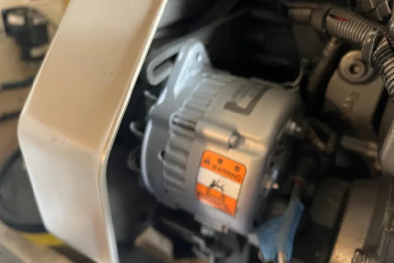 Slide: The Image of Engine component of a 2008 Luhrs 35 Convertible boat, featuring a visible warning label. - 46