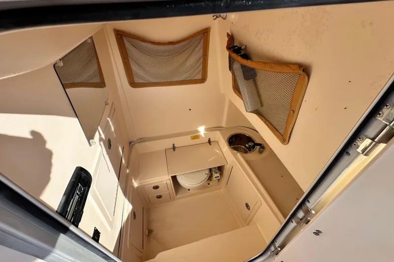 Slide: The Image of 2005 Grady-White Release 283 boat interior with storage and sink. - 11