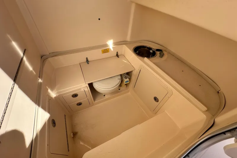 Slide: The Image of 2005 Grady-White Release 283 boat interior with compact bathroom and sink. - 12