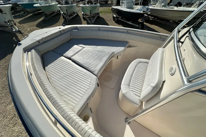 Slide: The Image of 2005 Grady-White Release 283 boat interior with cushioned seating and storage. - 14