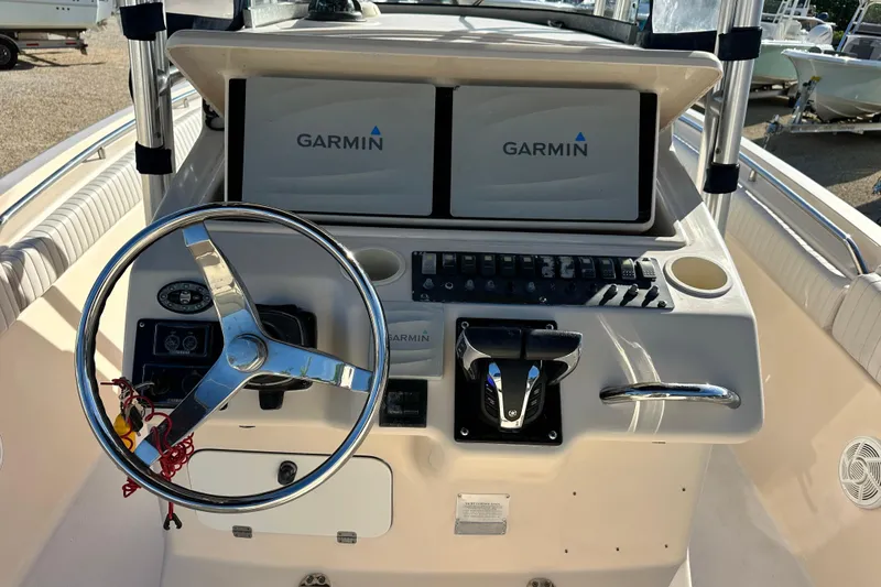 Slide: The Image of 2005 Grady-White Release 283 boat dashboard with Garmin navigation system and steering wheel. - 18