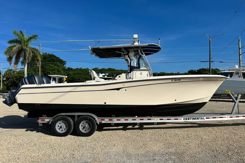 Slide: The Image of 2005 Grady-White Release 283 boat on trailer, parked outdoors under clear blue sky. - 2
