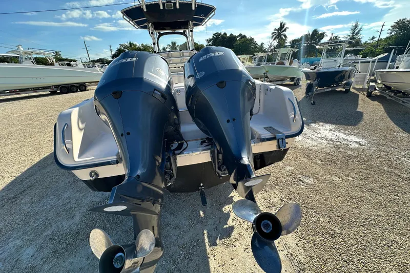 Slide: The Image of 2005 Grady-White Release 283 boat with dual outboard engines in a sunny marina. - 4