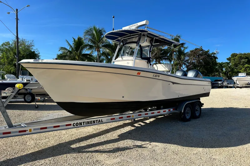 Slide: The Image of 2005 Grady-White Release 283 boat on trailer, parked outdoors under clear blue sky. - 6
