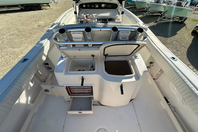 Slide: The Image of 2005 Grady-White Release 283 boat interior with open storage compartments and rod holders. - 9