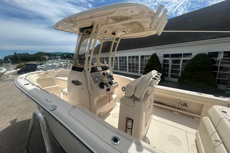 Slide: The Image of 2023 Grady White Fisherman boat with modern console and seating, docked outdoors. - 3