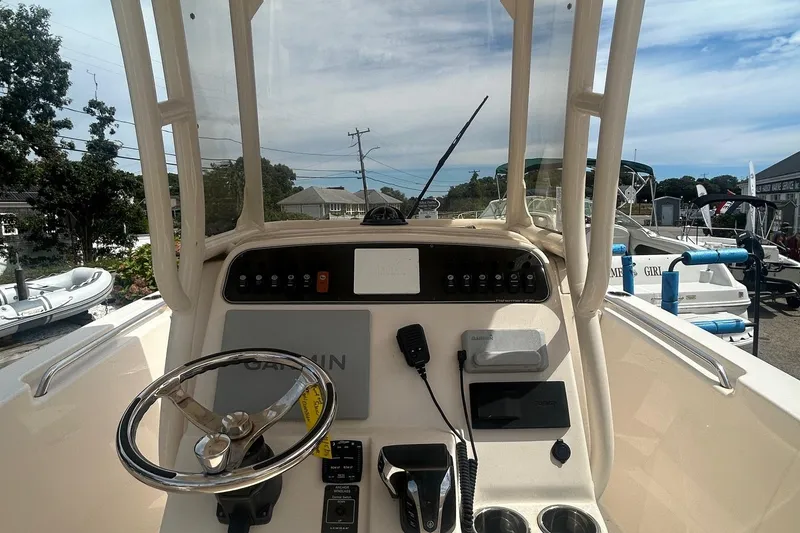 Slide: The Image of 2023 Grady White Fisherman boat dashboard with steering wheel and controls. - 7