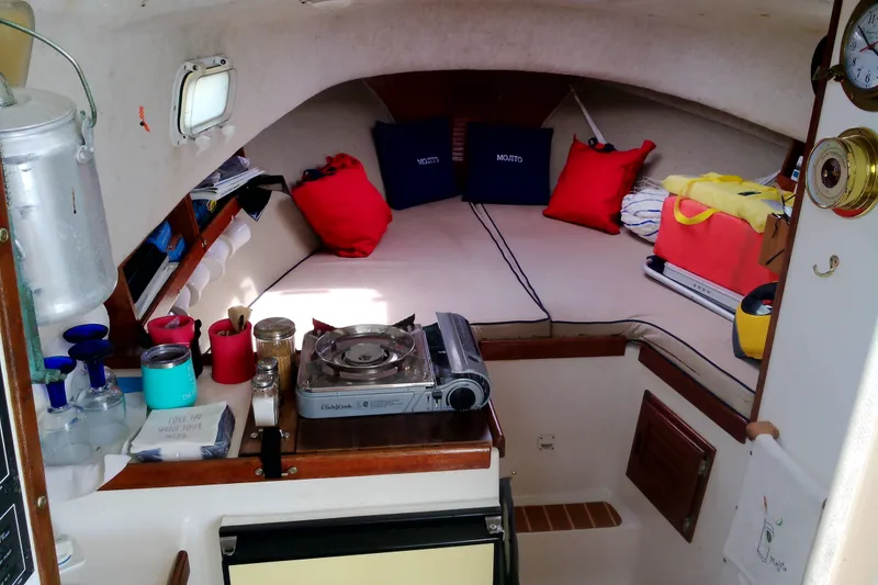 Slide: The Image of Interior of a 2000 Atlas Boat Works Acadia 25, featuring cozy cabin and compact kitchen. - 12