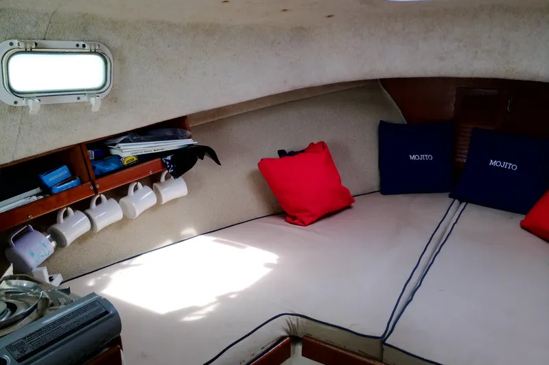 Slide: The Image of Interior of 2000 Atlas Boat Works Acadia 25 with cozy seating and nautical decor. - 13