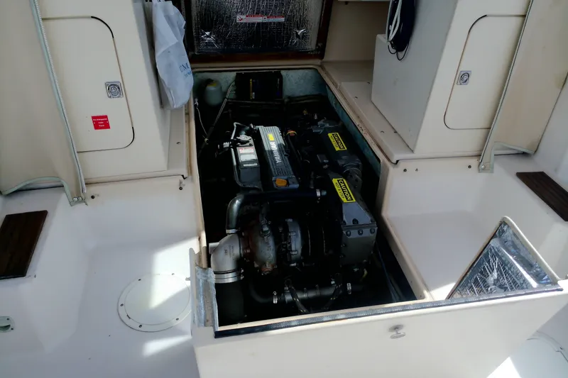 Slide: The Image of Engine compartment of 2000 Atlas Boat Works Acadia 25, showcasing detailed mechanical components. - 16