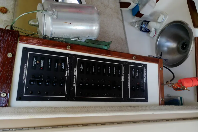 Slide: The Image of Control panel of a 2000 Atlas Boat Works Acadia 25, featuring AC and DC power centers. - 22