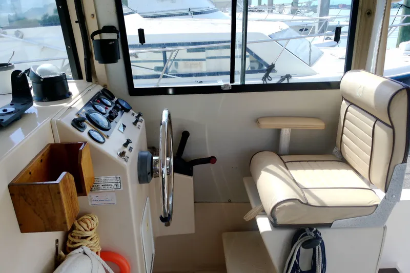 Slide: The Image of Interior helm of 2000 Atlas Boat Works Acadia 25, featuring steering wheel and gauges. - 29