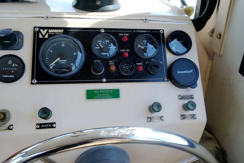 Slide: The Image of Control panel of a 2000 Atlas Boat Works Acadia 25, featuring gauges and switches. - 36