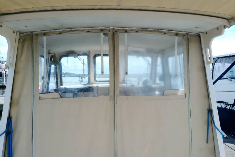 Slide: The Image of Atlas Boat Works Acadia 25, 2000 model, enclosed cabin view at dock. - 7