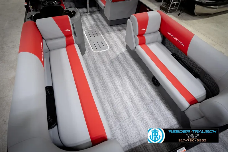 Slide: The Image of 2026 Bennington 22 SLJ boat interior with red and gray seating, Reeder-Trausch Marine logo. - 12