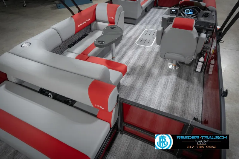 Slide: The Image of 2026 Bennington 22 SLJ pontoon boat interior with red and gray seating, modern dashboard. - 13