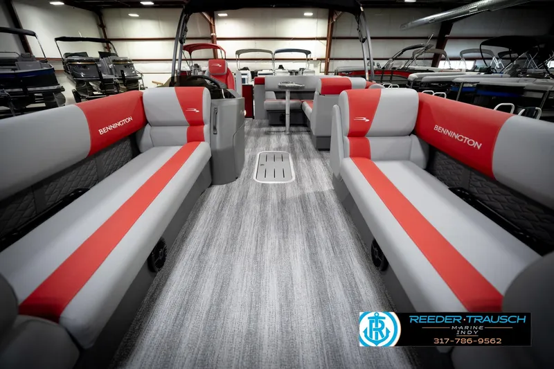 Slide: The Image of 2026 Bennington 22 SLJ pontoon boat interior with red and gray seating in showroom. - 15