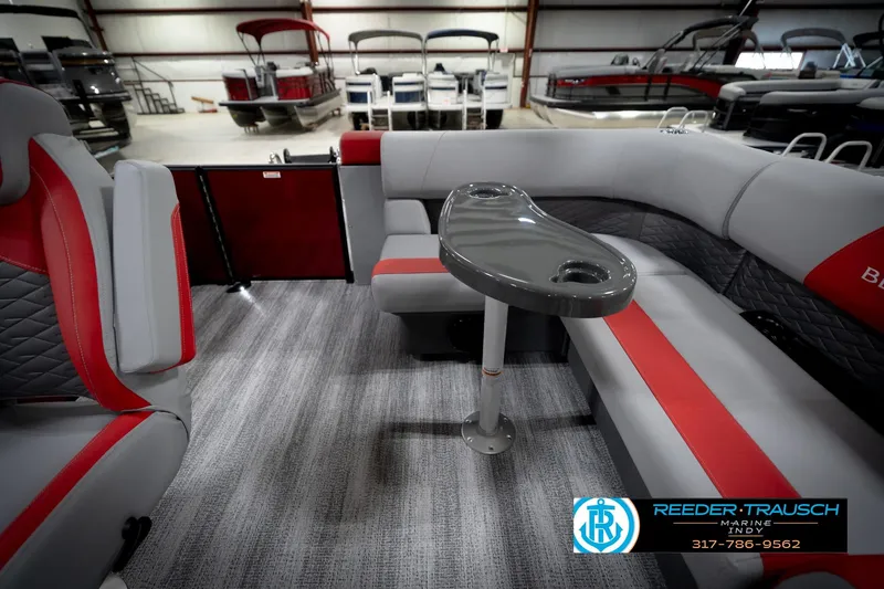 Slide: The Image of 2026 Bennington 22 SLJ pontoon boat interior with gray and red seating, showroom display. - 17