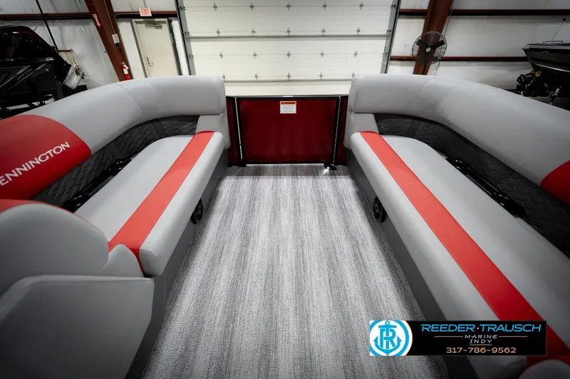 Slide: The Image of 2026 Bennington 22 SLJ pontoon boat interior with red and gray seating in showroom. - 20